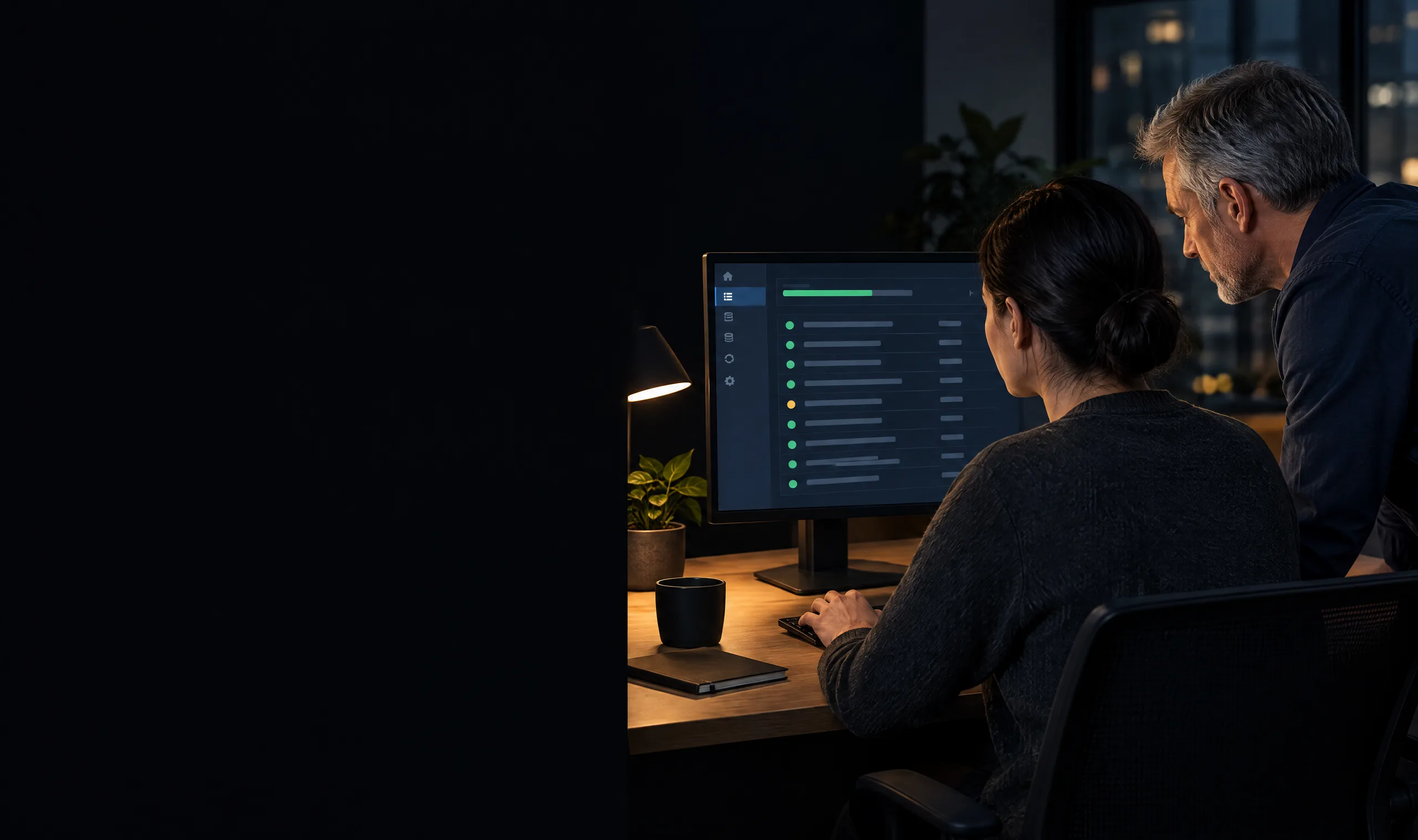 An integration developer and operations lead check an order sync log on a monitor in a dark office An integration developer and operations lead check an order sync log on a monitor in a dark office