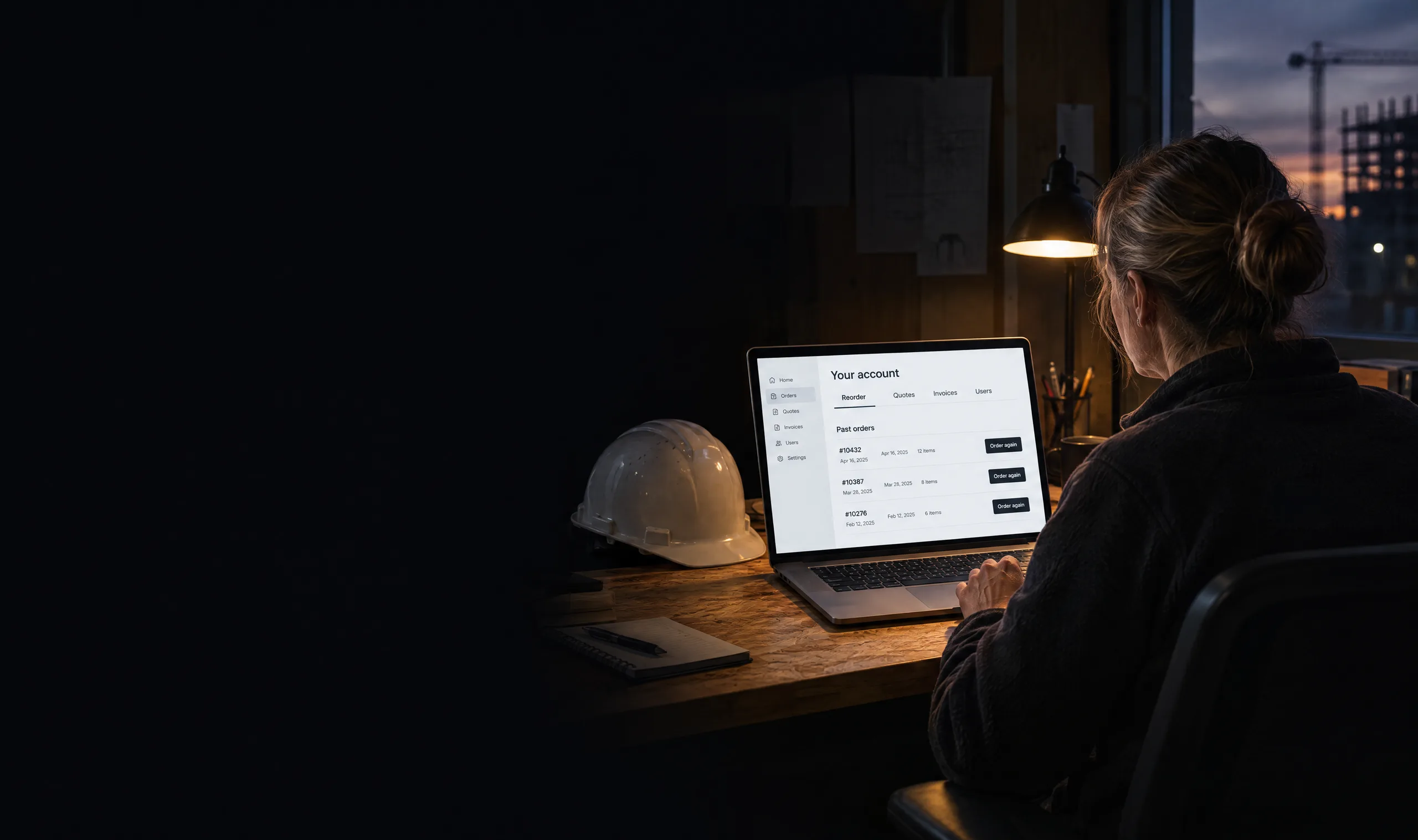 Purchasing manager reordering supplies from her company account on a laptop in a site office at dusk Purchasing manager reordering supplies from her company account on a laptop in a site office at dusk