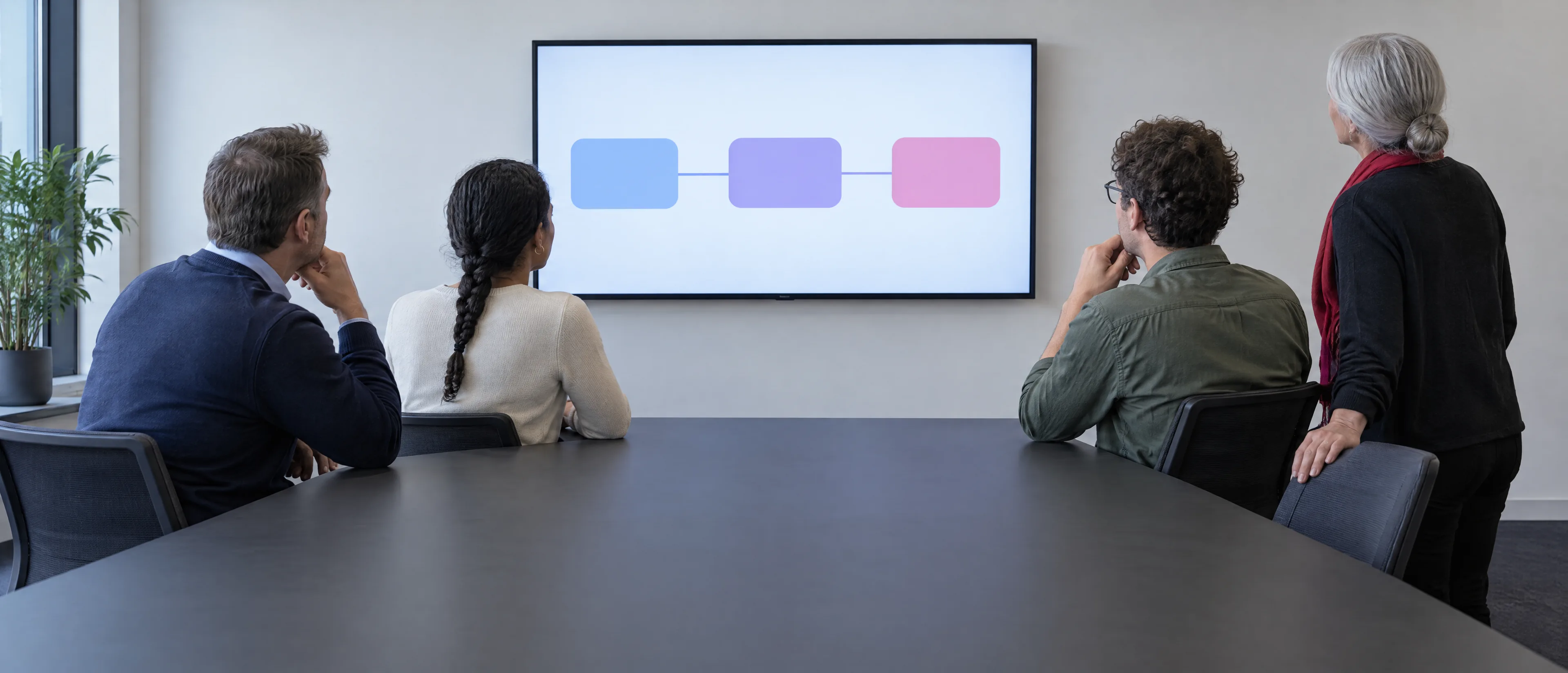 Developers, an ERP engineer and a marketer plan a headless store together in front of one wall screen Developers, an ERP engineer and a marketer plan a headless store together in front of one wall screen