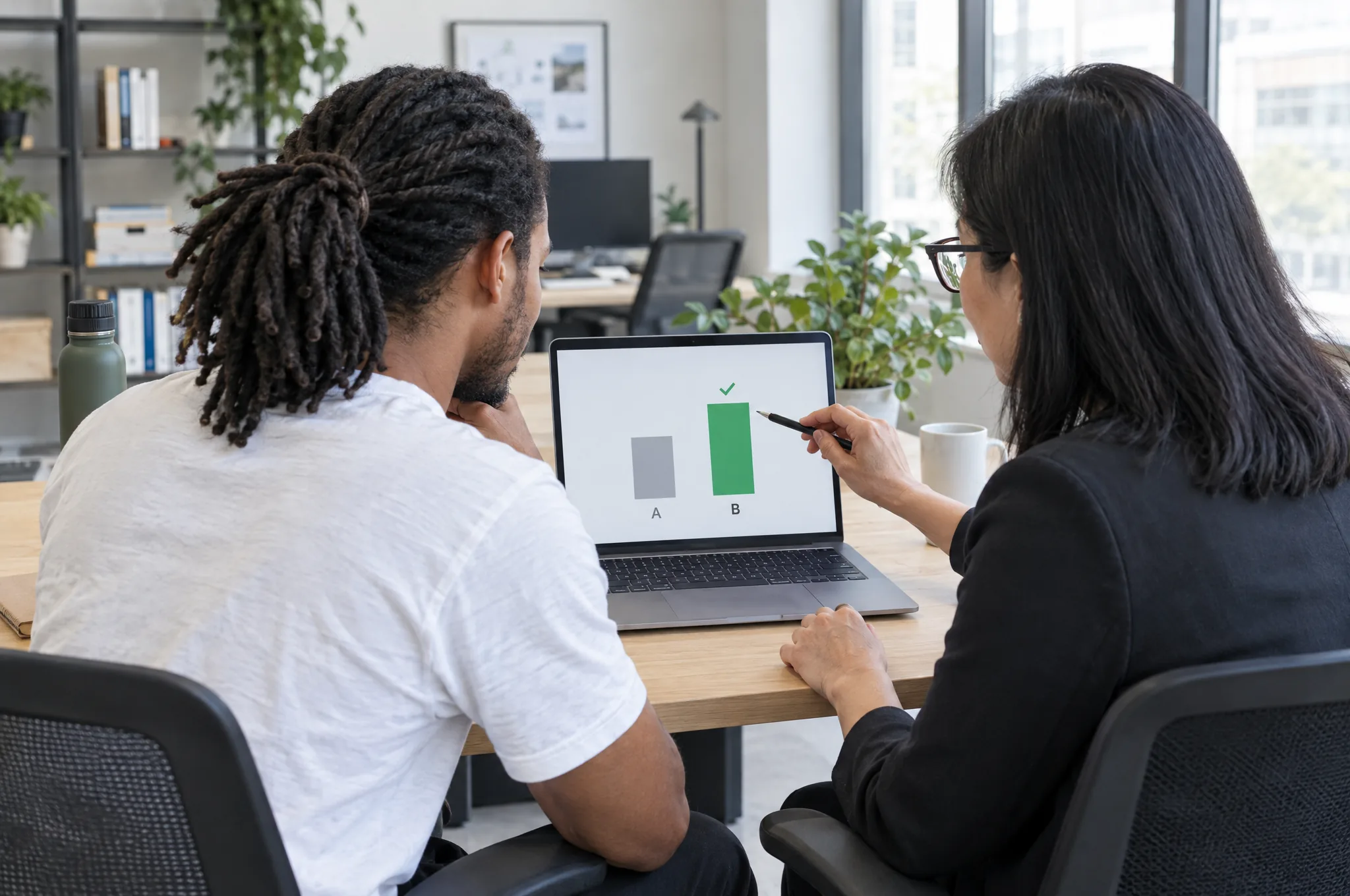 A developer and a marketer check a test result on a laptop before a new page ships A developer and a marketer check a test result on a laptop before a new page ships