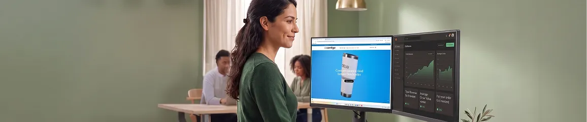 Ecommerce analyst reviewing Adobe Commerce revenue and conversion growth metrics on dual monitors, natural light Ecommerce analyst reviewing Adobe Commerce revenue and conversion growth metrics on dual monitors, natural light