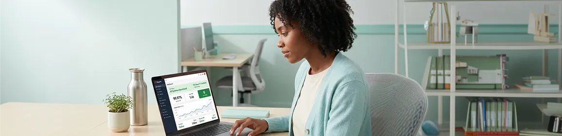 Ecommerce manager calmly reviewing resolved Adobe Commerce store performance on laptop Ecommerce manager calmly reviewing resolved Adobe Commerce store performance on laptop