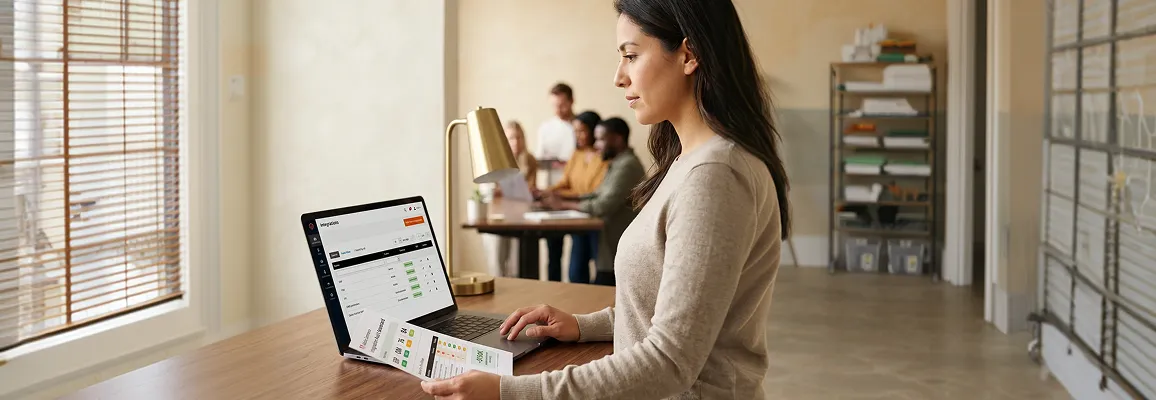 Operations lead reviewing Adobe Commerce integration audit document at her desk, morning light Operations lead reviewing Adobe Commerce integration audit document at her desk, morning light