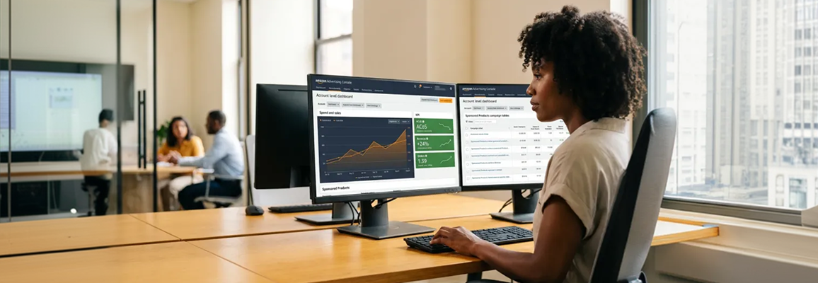 Amazon pay-per-click analyst reviewing campaign audit findings on multiple screens at workstation, screen glow, focused side profile Amazon pay-per-click analyst reviewing campaign audit findings on multiple screens at workstation, screen glow, focused side profile