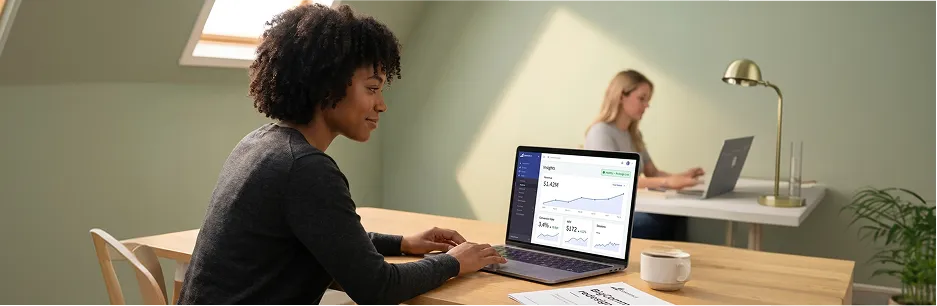 Merchant reviewing redesigned BigCommerce storefront with healthy conversion metrics, morning light Merchant reviewing redesigned BigCommerce storefront with healthy conversion metrics, morning light