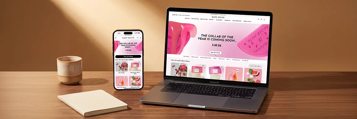 Clean desk with phone and laptop both showing the same responsive website design on different screen sizes Clean desk with phone and laptop both showing the same responsive website design on different screen sizes