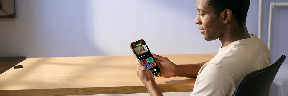 Product manager calmly reviewing a polished refined iOS app home screen on iPhone with a positive retention metric Product manager calmly reviewing a polished refined iOS app home screen on iPhone with a positive retention metric