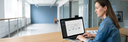 Android designer reviewing Jetpack Compose design handoff documentation on a laptop with morning window light in a professional workspace Android designer reviewing Jetpack Compose design handoff documentation on a laptop with morning window light in a professional workspace
