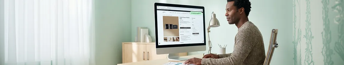 Ecommerce founder reviewing a rebuilt high-converting WooCommerce storefront on a monitor in a professional office setting Ecommerce founder reviewing a rebuilt high-converting WooCommerce storefront on a monitor in a professional office setting