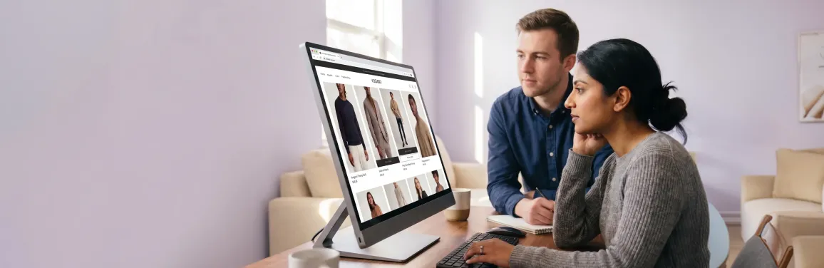 Developer and designer reviewing a custom headless ecommerce storefront design on a large studio monitor in natural light Developer and designer reviewing a custom headless ecommerce storefront design on a large studio monitor in natural light