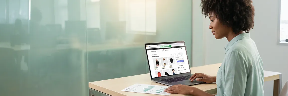 Ecommerce founder reviewing improved WooCommerce store conversion rate data on a laptop, calm and satisfied, in a professional office with natural light