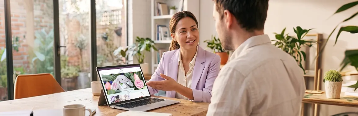 User experience designer and stakeholder reviewing Figma prototype on a large screen with attentive focus User experience designer and stakeholder reviewing Figma prototype on a large screen with attentive focus