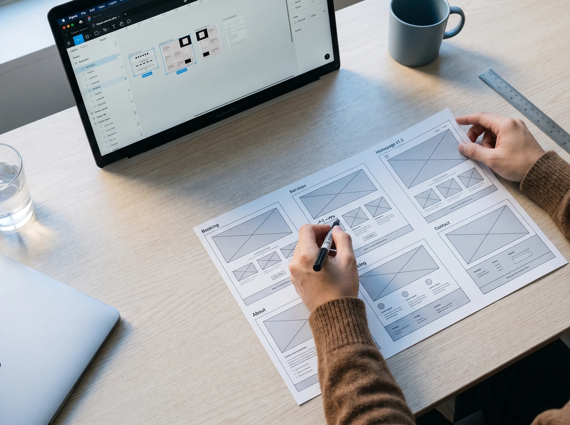 Designer arranging WordPress wireframe comps on a desk, overhead angle, morning light Designer arranging WordPress wireframe comps on a desk, overhead angle, morning light