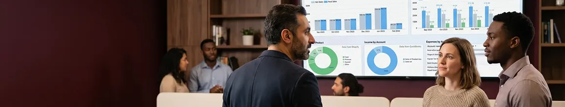 Ecommerce operations team in hub with multiple large screens showing revenue and order dashboards, natural overhead light Ecommerce operations team in hub with multiple large screens showing revenue and order dashboards, natural overhead light