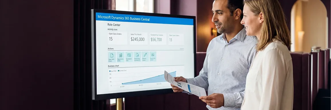 IT manager and business lead reviewing new Microsoft Dynamics 365 Business Central ERP system live on Azure infrastructure with natural office light and satisfied expressions IT manager and business lead reviewing new Microsoft Dynamics 365 Business Central ERP system live on Azure infrastructure with natural office light and satisfied expressions