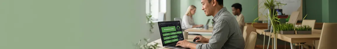 E-commerce operations lead at a tidy workstation reviewing a clean integrated multi-channel dashboard with green operational channel-health rows and zero SLA breaches, calm satisfied side profile E-commerce operations lead at a tidy workstation reviewing a clean integrated multi-channel dashboard with green operational channel-health rows and zero SLA breaches, calm satisfied side profile