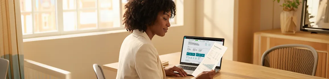 Finance director reviewing a reconciliation report printout at their desk the morning before an ERP go-live deadline Finance director reviewing a reconciliation report printout at their desk the morning before an ERP go-live deadline