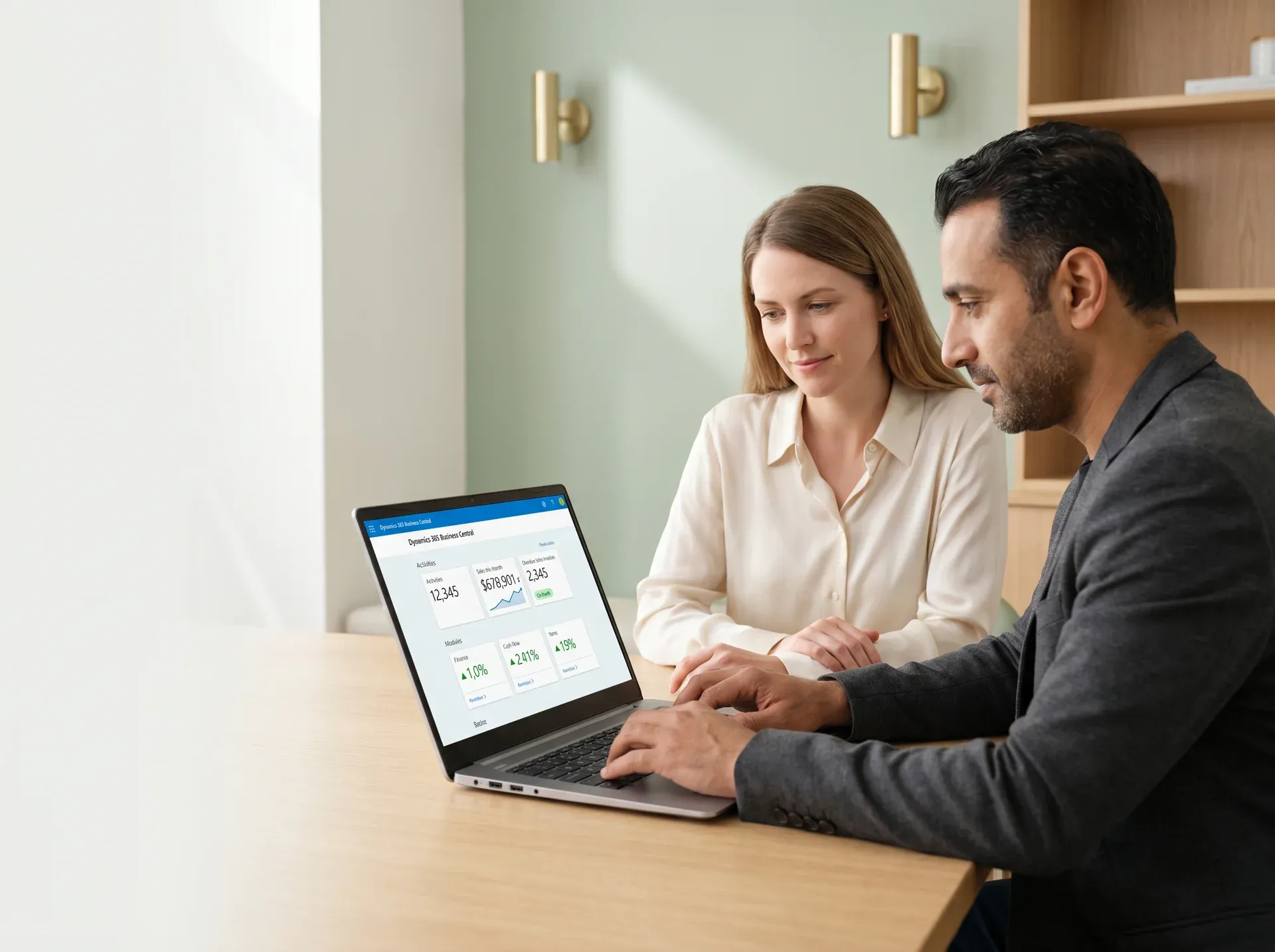 Business professionals reviewing a completed Business Central implementation together on a laptop screen. Business professionals reviewing a completed Business Central implementation together on a laptop screen.