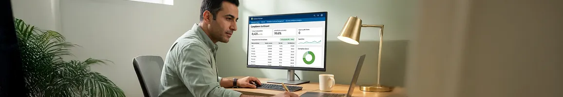 Tax accountant reviewing CCH SureTax compliance data on screen, natural desk light, focused side angle Tax accountant reviewing CCH SureTax compliance data on screen, natural desk light, focused side angle