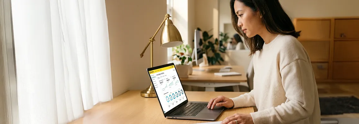 Merchant reviewing Mailchimp email campaign analytics dashboard, morning light