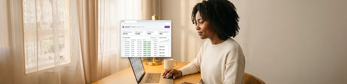 Ecommerce merchant reviewing automated marketplace order sync results on a laptop Ecommerce merchant reviewing automated marketplace order sync results on a laptop