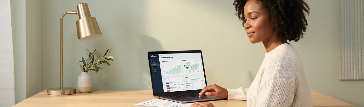 Marketing lead at a quiet desk studying video drop-off charts on a laptop Marketing lead at a quiet desk studying video drop-off charts on a laptop