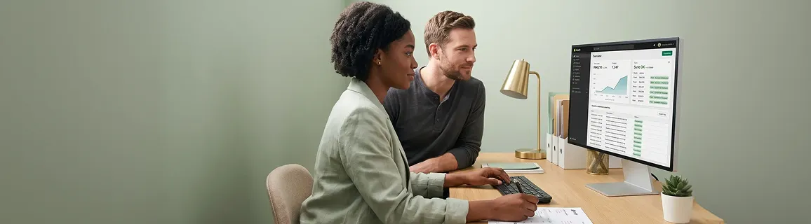 Operations team reviewing healthy Shopify and NetSuite integration sync dashboard with all green succeeded events in a calm organized workspace Operations team reviewing healthy Shopify and NetSuite integration sync dashboard with all green succeeded events in a calm organized workspace