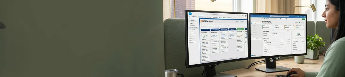 Sales and finance teams reviewing Salesforce and Dynamics 365 data at dual screens in shared office, natural light, focused Sales and finance teams reviewing Salesforce and Dynamics 365 data at dual screens in shared office, natural light, focused