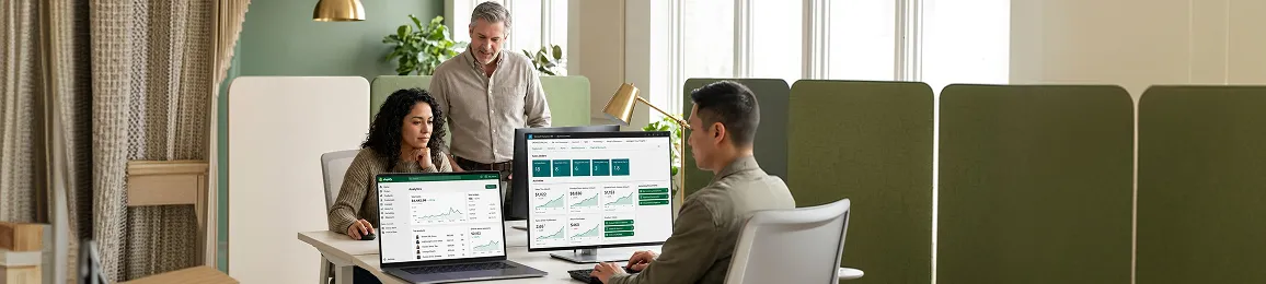 Business-to-business operations team reviewing unified ecommerce and ERP order dashboard after integration, focused at workstations, natural office light Business-to-business operations team reviewing unified ecommerce and ERP order dashboard after integration, focused at workstations, natural office light