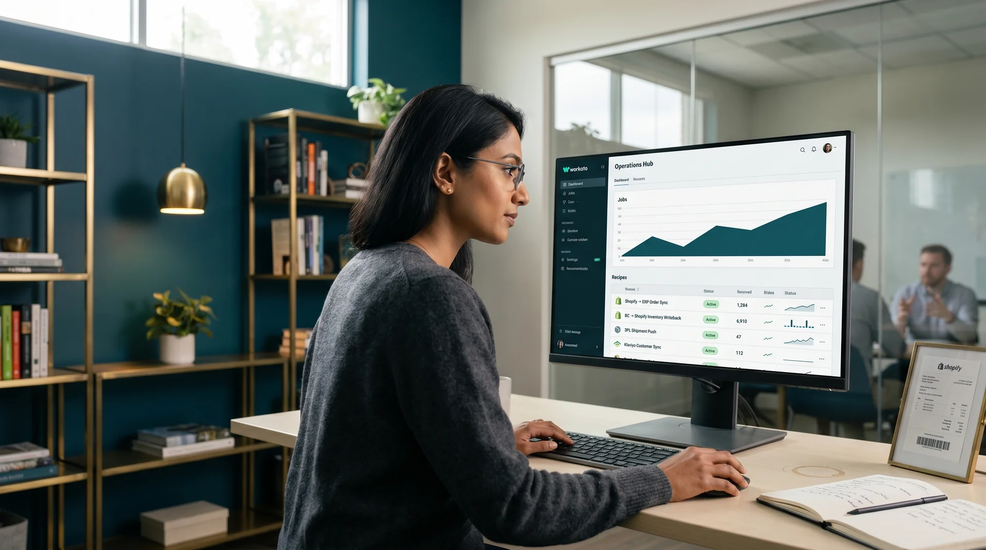 Operations analyst reviewing a live iPaaS integration dashboard showing connected systems and automated data flows Operations analyst reviewing a live iPaaS integration dashboard showing connected systems and automated data flows