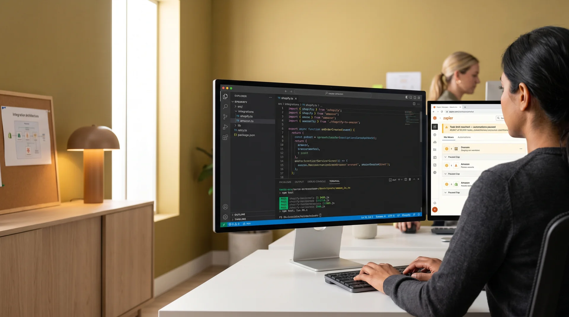 Developer reviewing a custom integration codebase replacing Zapier automations, with task limit warnings visible on a second screen Developer reviewing a custom integration codebase replacing Zapier automations, with task limit warnings visible on a second screen