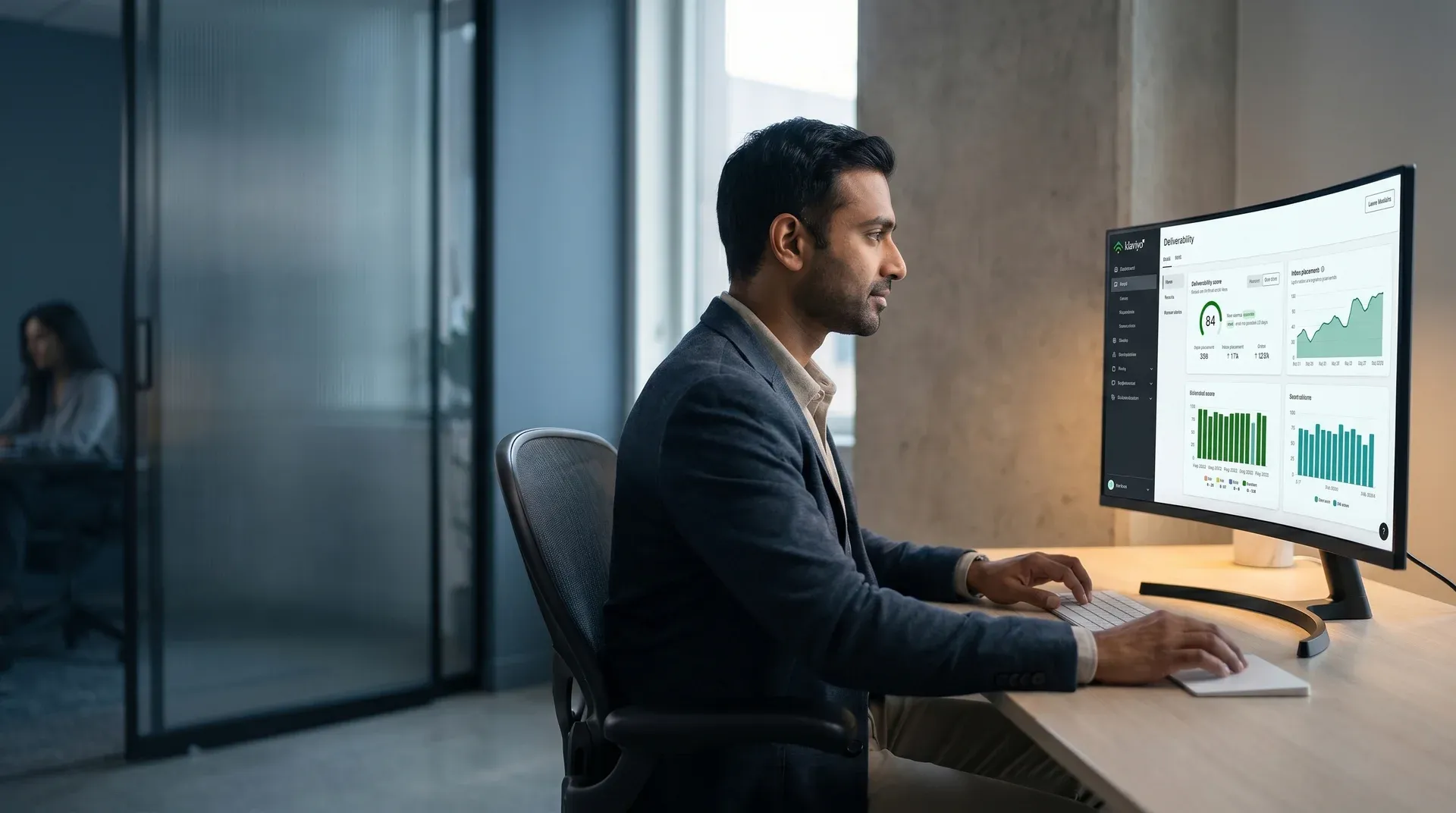 Email deliverability specialist reviewing inbox placement metrics on dashboard, warm natural office light Email deliverability specialist reviewing inbox placement metrics on dashboard, warm natural office light