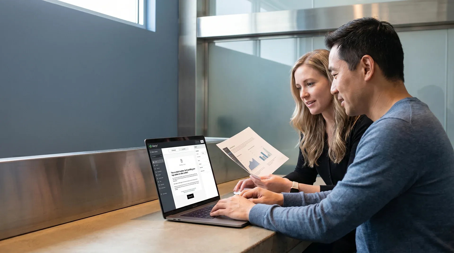 Designer and client reviewing Klaviyo email mockups together at a desk in natural light