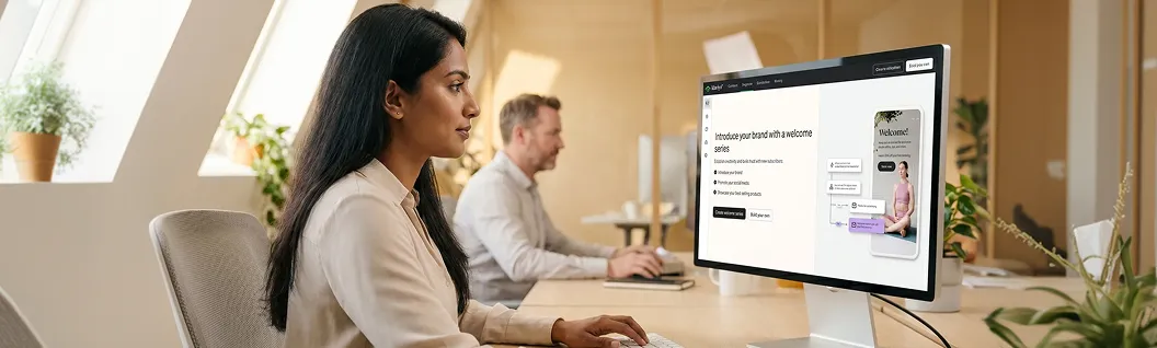 Lifecycle manager reviewing a Klaviyo welcome email campaign on desktop in a warm, naturally lit office Lifecycle manager reviewing a Klaviyo welcome email campaign on desktop in a warm, naturally lit office