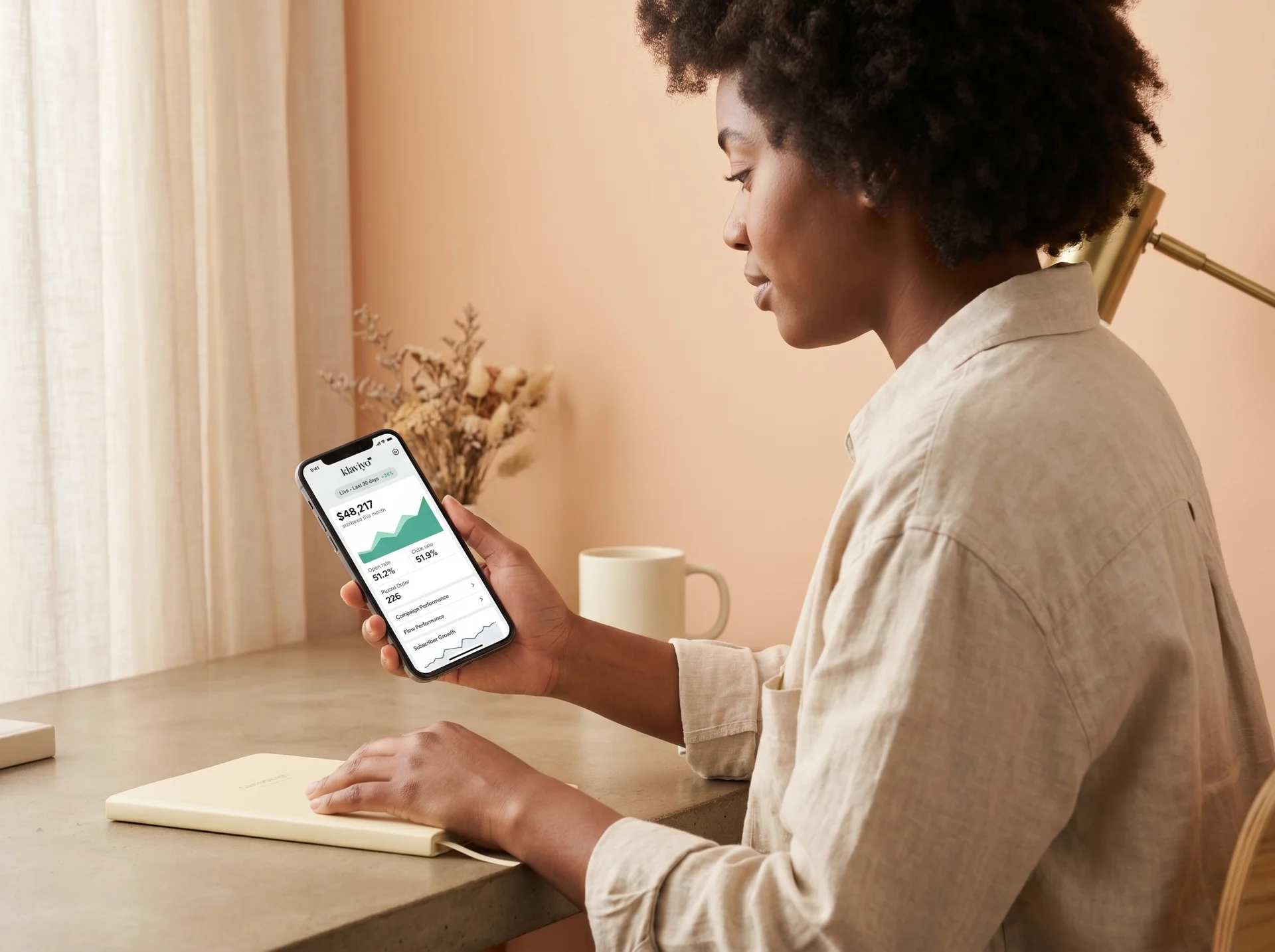 Ecommerce founder reviewing Klaviyo email revenue results on mobile phone in a candid, authentic moment Ecommerce founder reviewing Klaviyo email revenue results on mobile phone in a candid, authentic moment