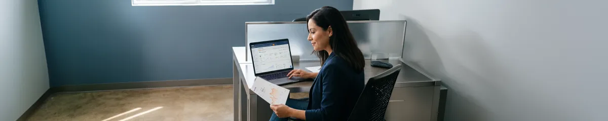 Marketing director calmly reviewing recovered organic traffic analytics climbing back up, overhead office light Marketing director calmly reviewing recovered organic traffic analytics climbing back up, overhead office light