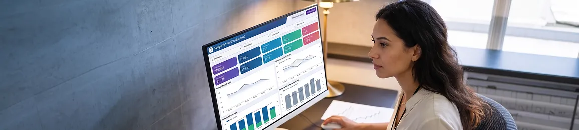 PPC manager reviewing optimized campaign performance results showing improved return on ad spend and lower cost per acquisition, warm desk lighting, satisfied expression PPC manager reviewing optimized campaign performance results showing improved return on ad spend and lower cost per acquisition, warm desk lighting, satisfied expression