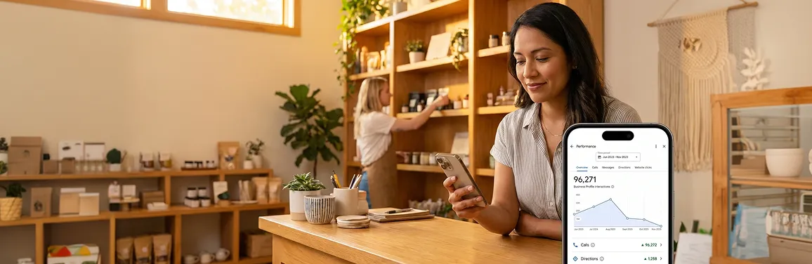 Small business owner checking local search results on phone in their shop with warm natural light Small business owner checking local search results on phone in their shop with warm natural light
