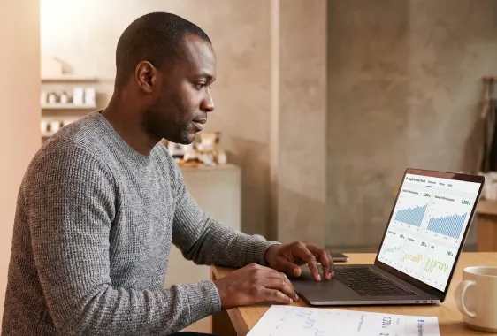 Small business owner at desk reviewing a healthy Google Business Profile performance dashboard with calls, directions and views climbing Small business owner at desk reviewing a healthy Google Business Profile performance dashboard with calls, directions and views climbing