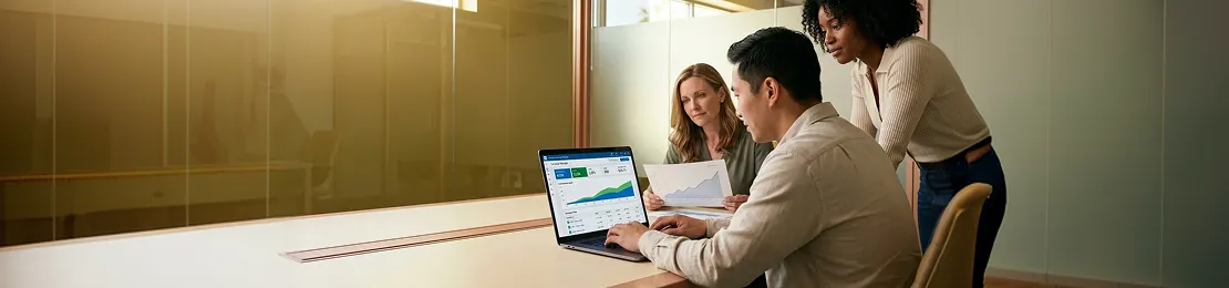 B2B marketing team at conference table reviewing digital campaign performance data on laptops, glass-walled meeting room, natural daylight B2B marketing team at conference table reviewing digital campaign performance data on laptops, glass-walled meeting room, natural daylight