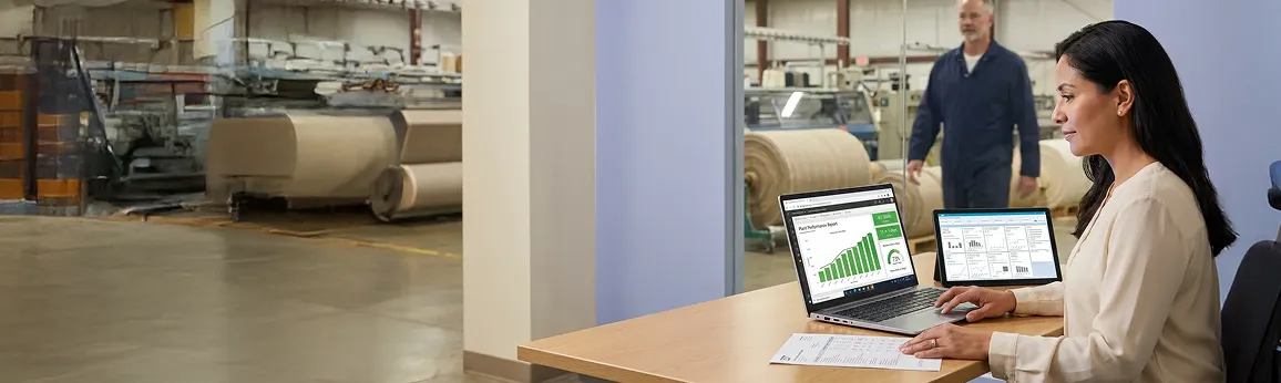 Finance controller at a laptop inside a textile processing plant reviewing a live SAP Power BI report Finance controller at a laptop inside a textile processing plant reviewing a live SAP Power BI report