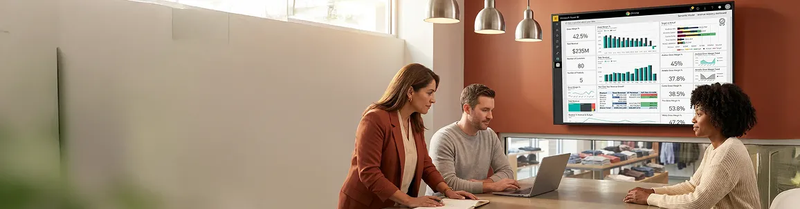 Apparel retail finance team reviewing stabilized Power BI revenue recovery dashboard on a wall display Apparel retail finance team reviewing stabilized Power BI revenue recovery dashboard on a wall display