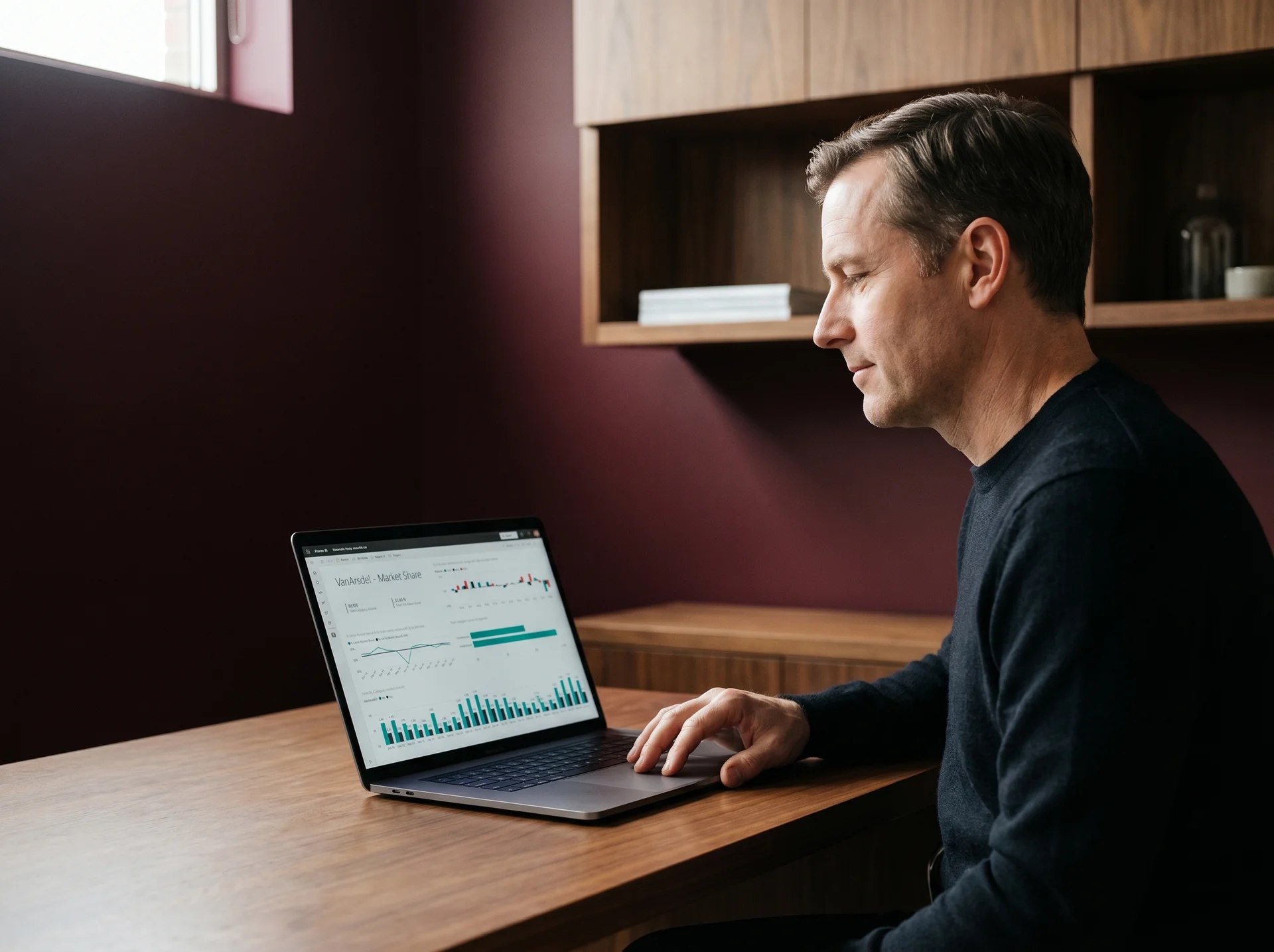 Analytics lead reviewing a completed Power BI workspace at a laptop after finishing the Looker to Power BI migration Analytics lead reviewing a completed Power BI workspace at a laptop after finishing the Looker to Power BI migration