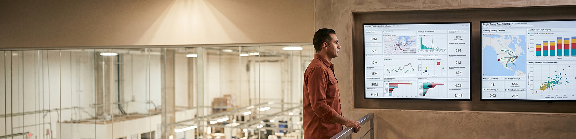 Manufacturing operations manager reviewing Power BI financial and operations performance dashboard Manufacturing operations manager reviewing Power BI financial and operations performance dashboard