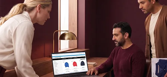 Corporate apparel and branded merchandise operations team reviewing catalog and order management workflows together Corporate apparel and branded merchandise operations team reviewing catalog and order management workflows together