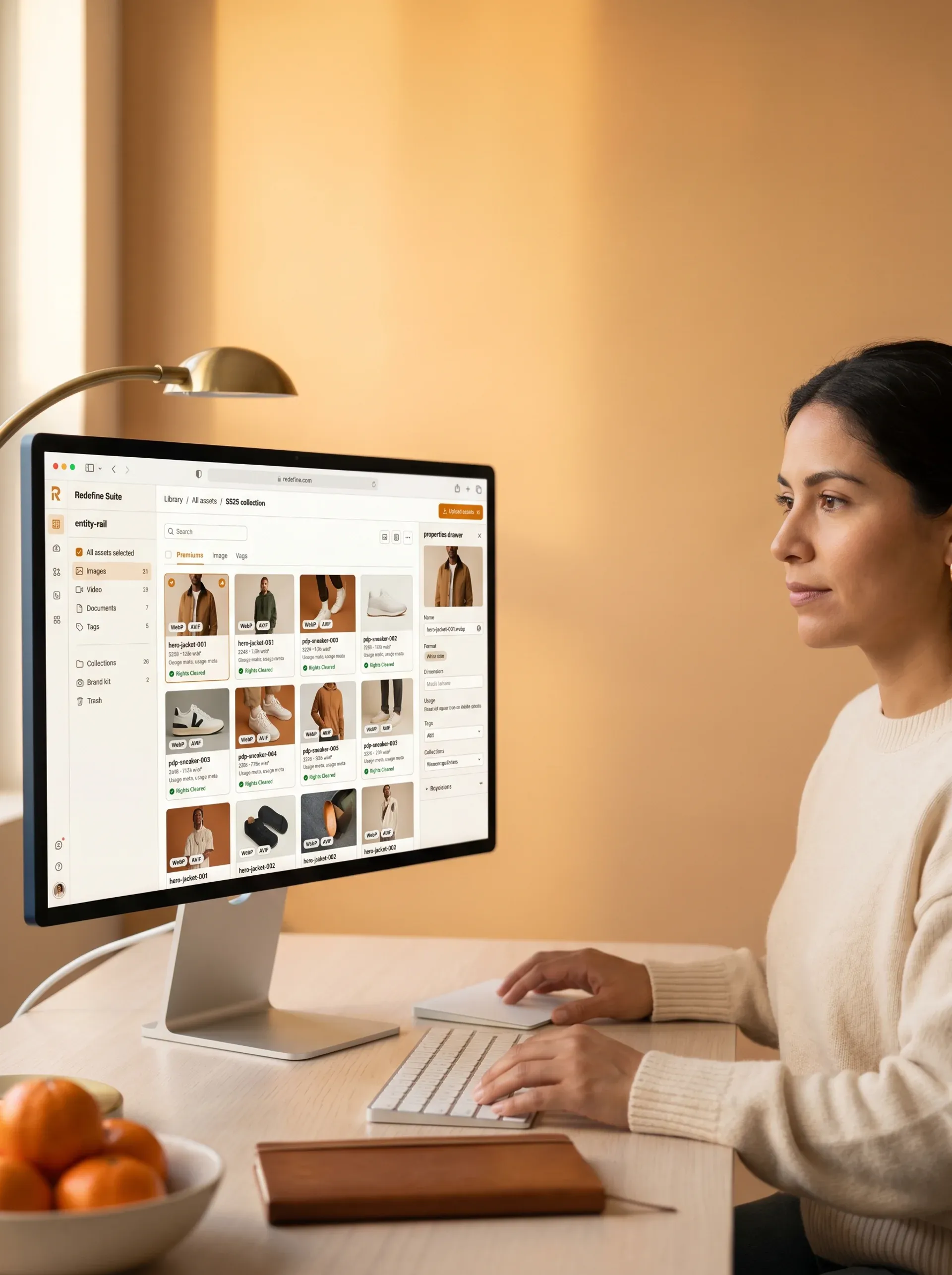 Ecommerce content team member reviewing an organised digital asset management library on a large monitor Ecommerce content team member reviewing an organised digital asset management library on a large monitor