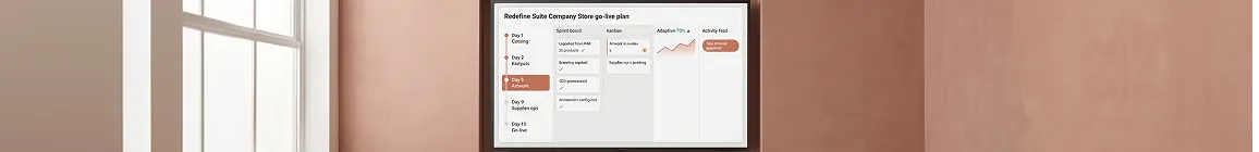 Brand team and operations lead at sprint review reviewing the company store go-live plan on a screen Brand team and operations lead at sprint review reviewing the company store go-live plan on a screen