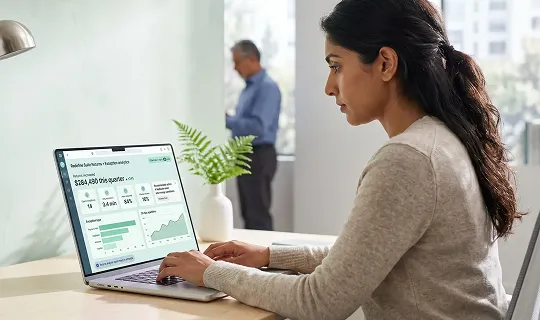 Ecommerce operations analyst reviewing returns and exception data on laptop screen in a bright modern office Ecommerce operations analyst reviewing returns and exception data on laptop screen in a bright modern office