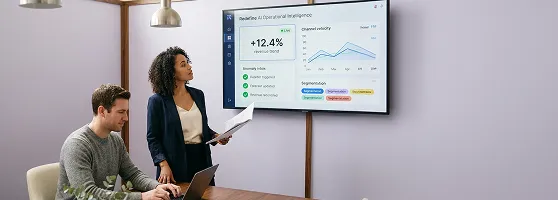 Retail analytics team reviewing AI-powered revenue recovery dashboard showing predictive segmentation insights Retail analytics team reviewing AI-powered revenue recovery dashboard showing predictive segmentation insights