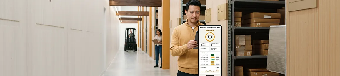 Warehouse manager reviewing inventory exception reports and service-level agreement status on a tablet in a warehouse Warehouse manager reviewing inventory exception reports and service-level agreement status on a tablet in a warehouse